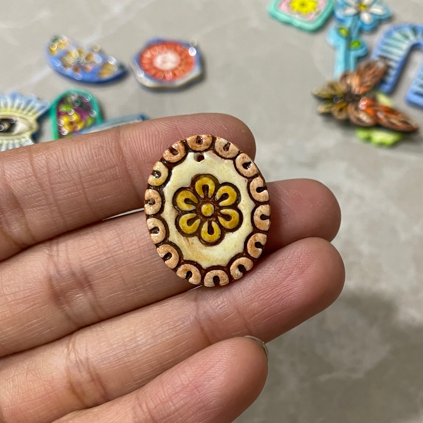 CN 44 - Traditional Oval Warli Flower Textured Hand Painted - Handmade Clay Charm